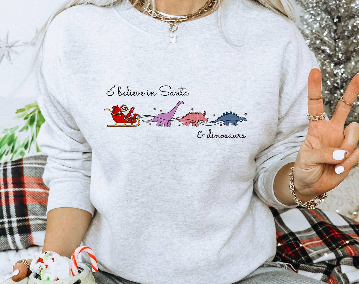 I Believe in Santa & Dinosaurs - Funny Christmas Sweatshirt T-Shirts, Hoodie | PodTeesHub.com