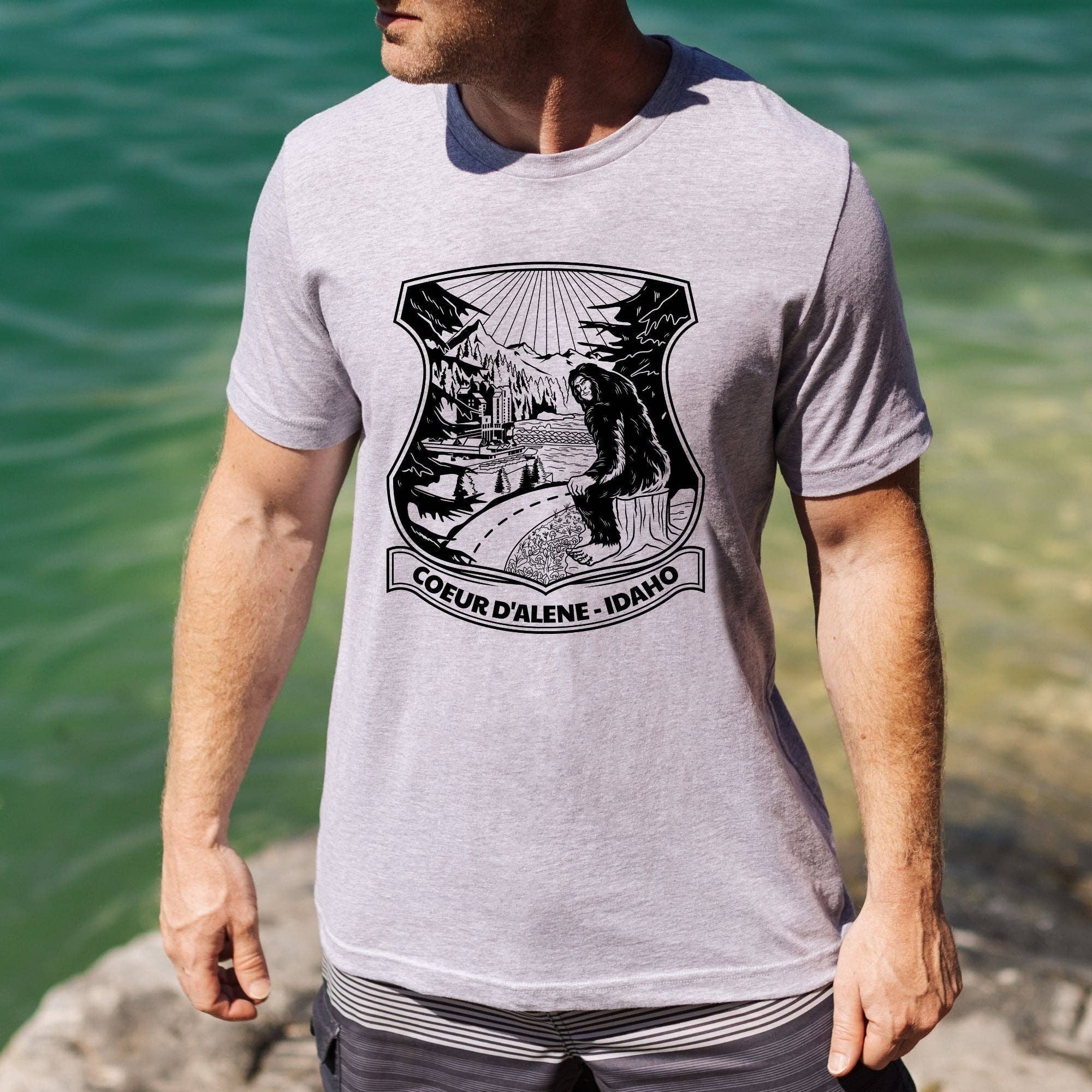Bigfoot Overlooking Coeur D'alene Idaho Unisex Shirt Hoodie, Sweatshirt | PodTeesHub.com