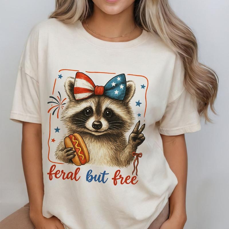 Coquette Feral but Free Raccoon Shirt, Cute USA Top for Women, Funny 4th of July Look, Patriotic Summer Outfit,...
