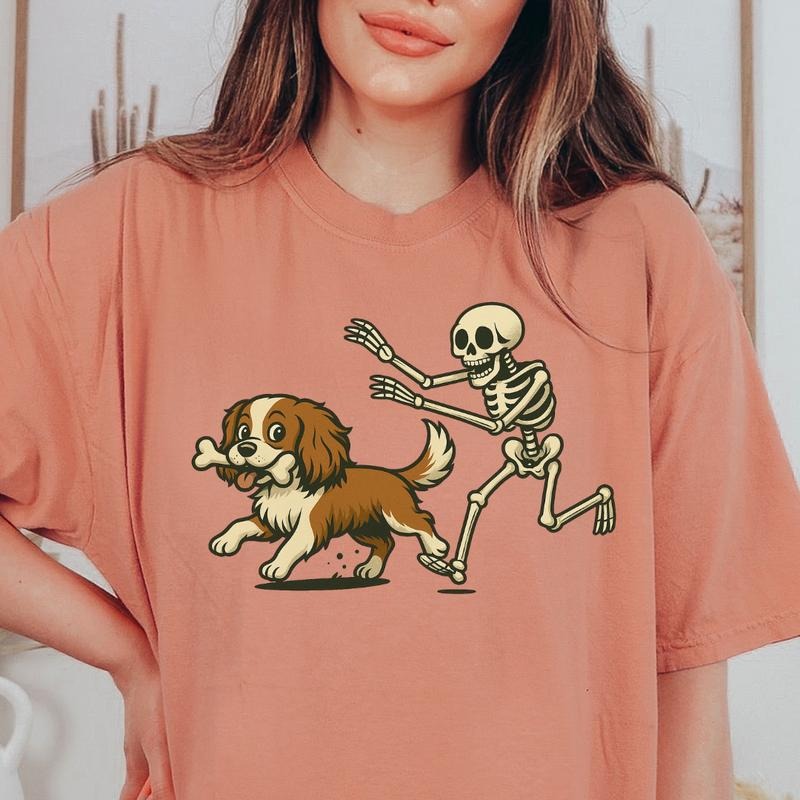 Funny Skeleton Chasing King Charles Spaniel Dog Halloween T-Shirt | Spooky Graphic Tee Comfort Colors Style 100%...
