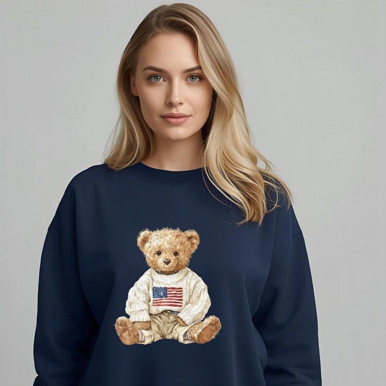 Cozy Teddy Bear Sweatshirt Featuring USA Flag, Unisex Crewneck Sweatshirt, Gift for Him/Her, Casual Wear, Fall Fashion,...