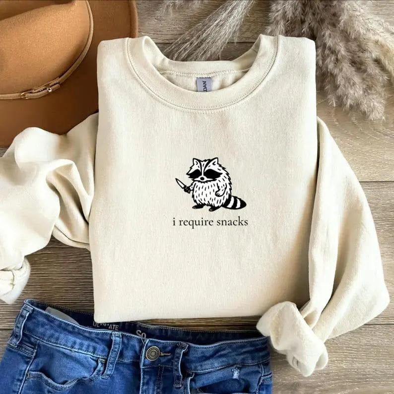 I Require Snacks Raccoon sweatshirt, a sarcastic and funny crewneck with playful humor, cozy comfort, and a quirky design...