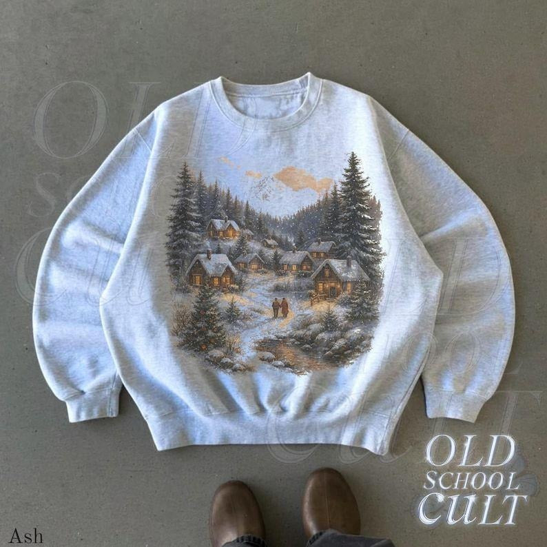 Retro Christmas Winter Village Sweatshirt , 90s Vintage Mountain Pine Trees Decorated Cabins T-shirt, Boho Unisex...