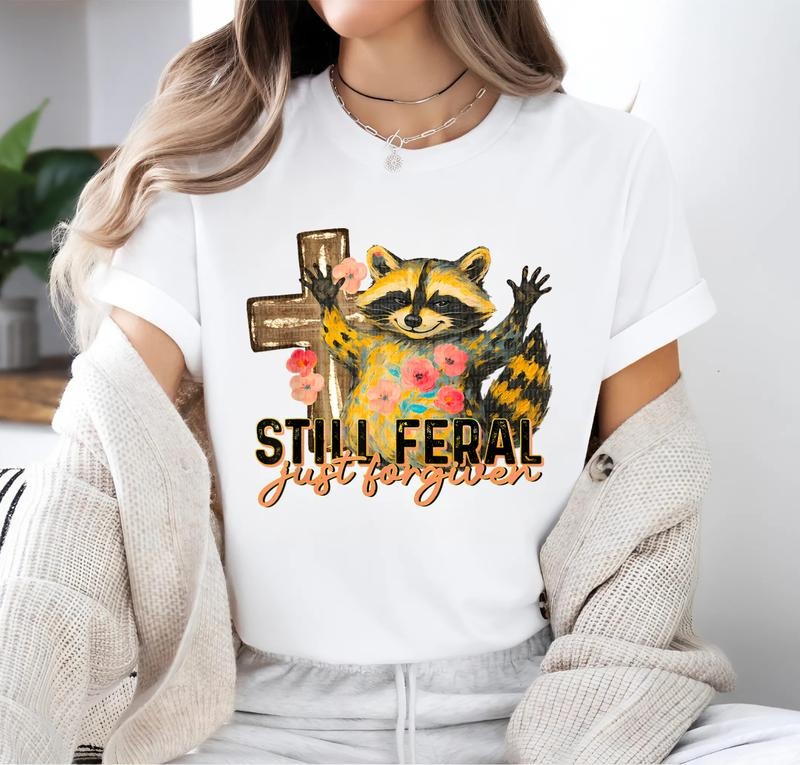 Still Feral Just Forgiven Funny Christian Raccoon Faith T-Shirt Hoodie, Sweatshirt | PodTeesHub.com