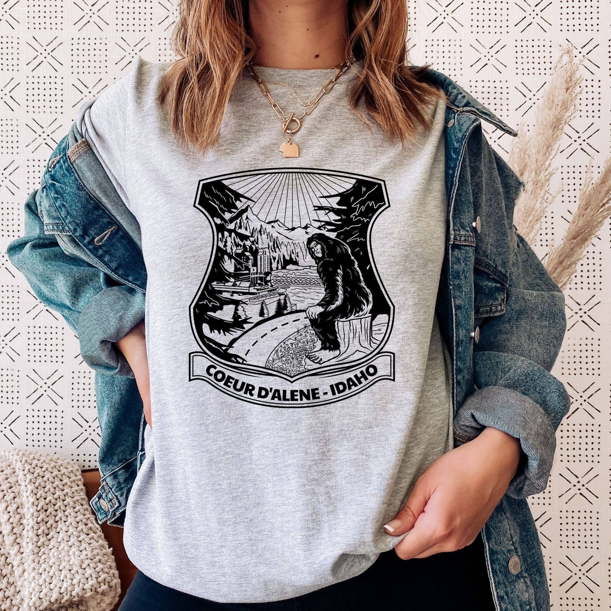 Bigfoot Overlooking Coeur D'alene Idaho Unisex T-Shirt Hoodie, Sweatshirt | PodTeesHub.com