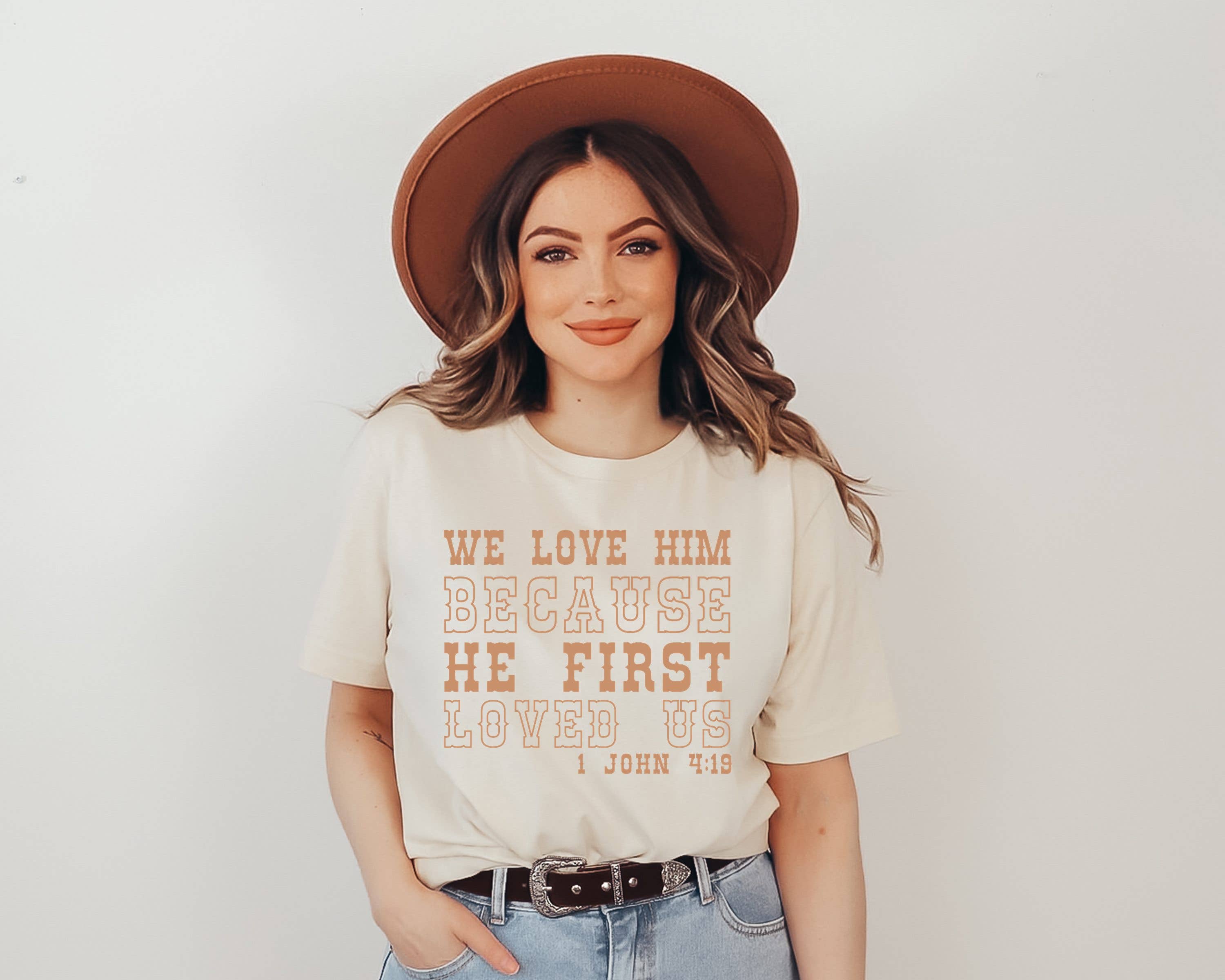 Love Him Because He First Loved Us Western Graphic Tee Hoodie, Sweatshirt | PodTeesHub.com