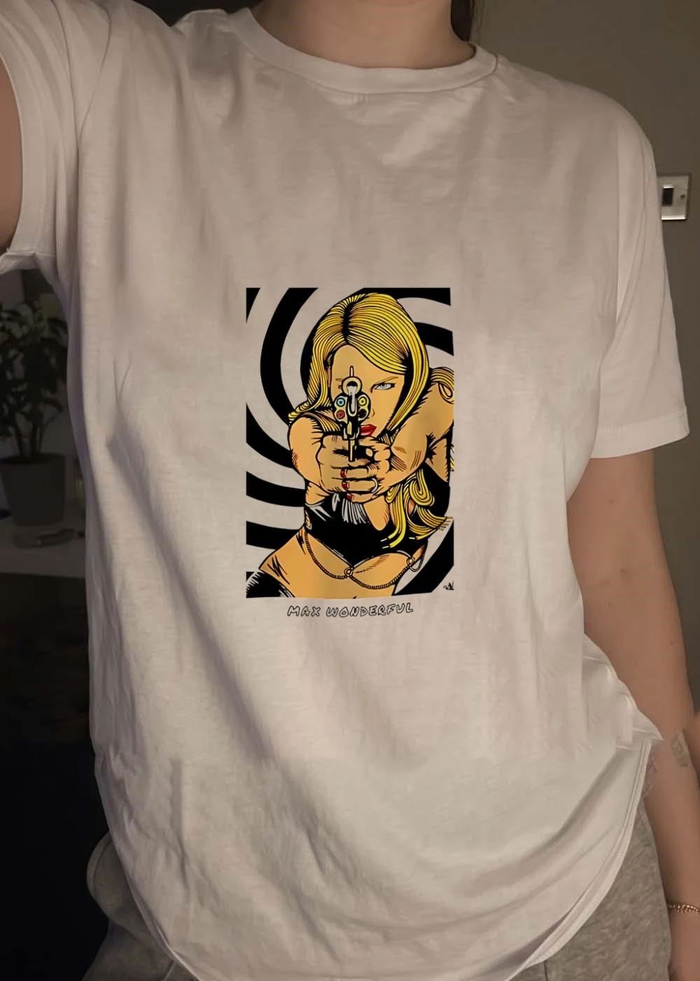 Max Wonderful blonde woman blue eyes aiming gun black bodysuit gold chain black white spiral shirt