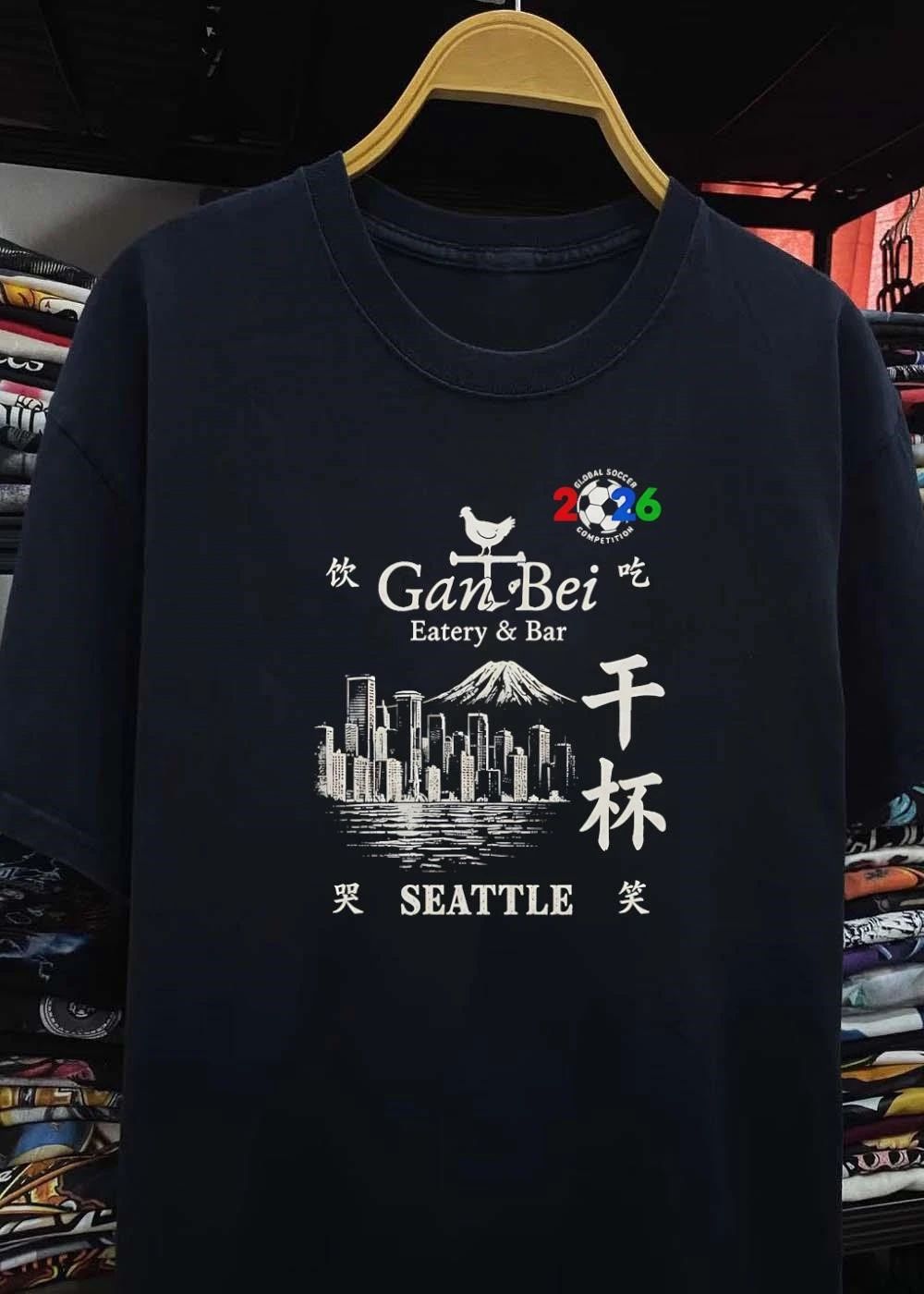 Gan Bei Seattle Drink Eat Laugh Cry Eatery Bar Global Soccer Competition 2026 T-Shirt