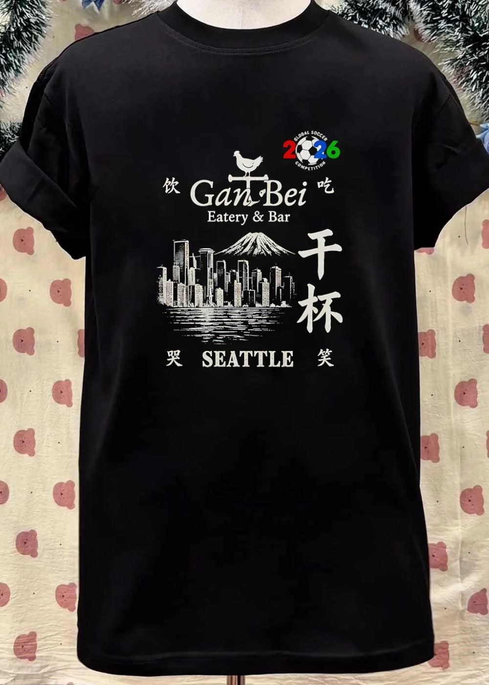 Gan Bei Seattle Drink Eat Laugh Cry Eatery Bar Global Soccer Competition 2026 T-Shirt