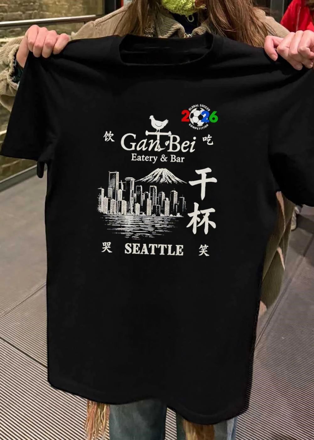 Gan Bei Seattle Drink Eat Laugh Cry Eatery Bar Global Soccer Competition 2026 T-Shirt