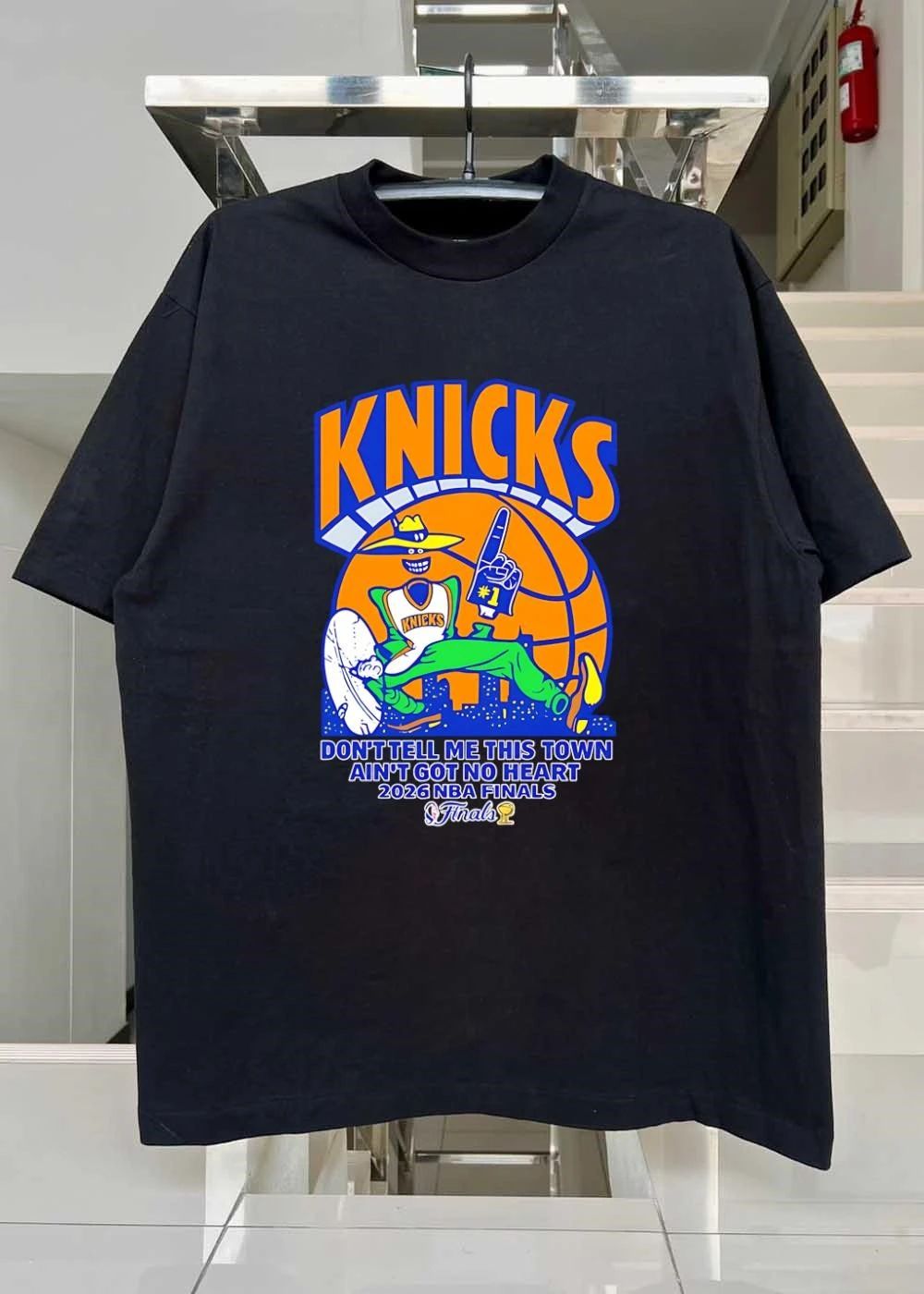 Knicks Apparel ‘ Mascot Holding Foam Finger ‘ Don’t Tell Me This Town Ain’t Got No Heart 2026 NBA Finals Knicks T-Shirt